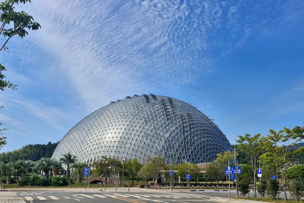Exterior view of the large glass Jungle Dome at Geoje Botanical Garden in Geoje Island.