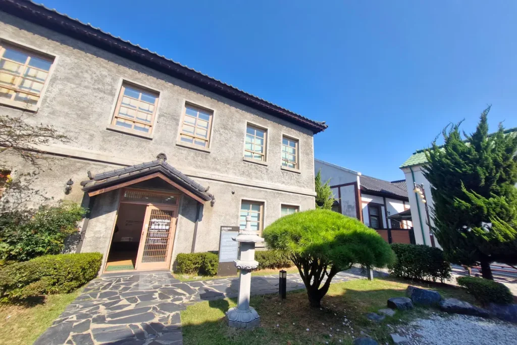 A preserved historic building in the Gunsan Modern History District under a blue sky.