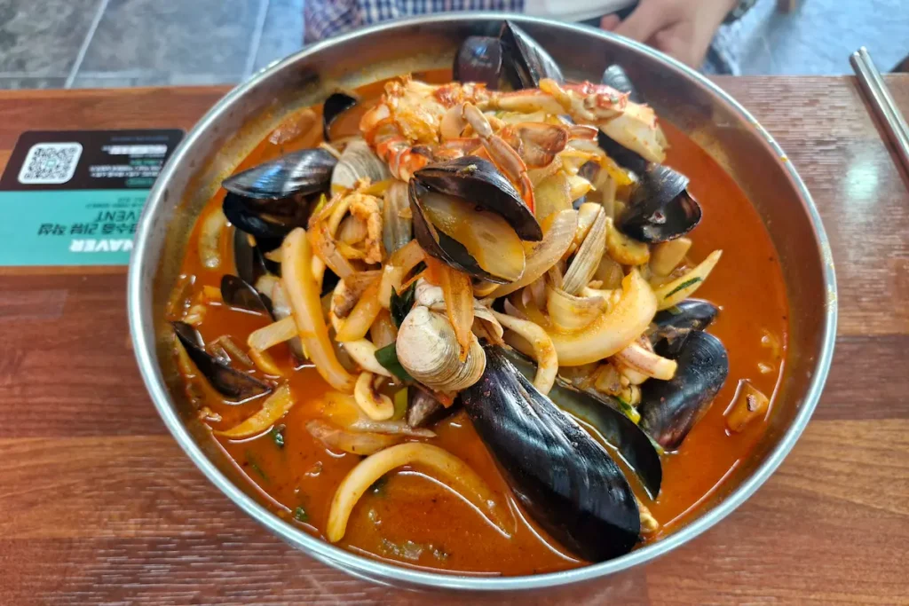 A large bowl of spicy Korean jjamppong noodles filled with seafood at Haemulhwa Jjamppong in Gunsan.