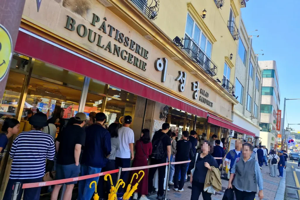 Visitors waiting in a long line outside Iseongdang bakery in Gunsan to buy its famous breads.