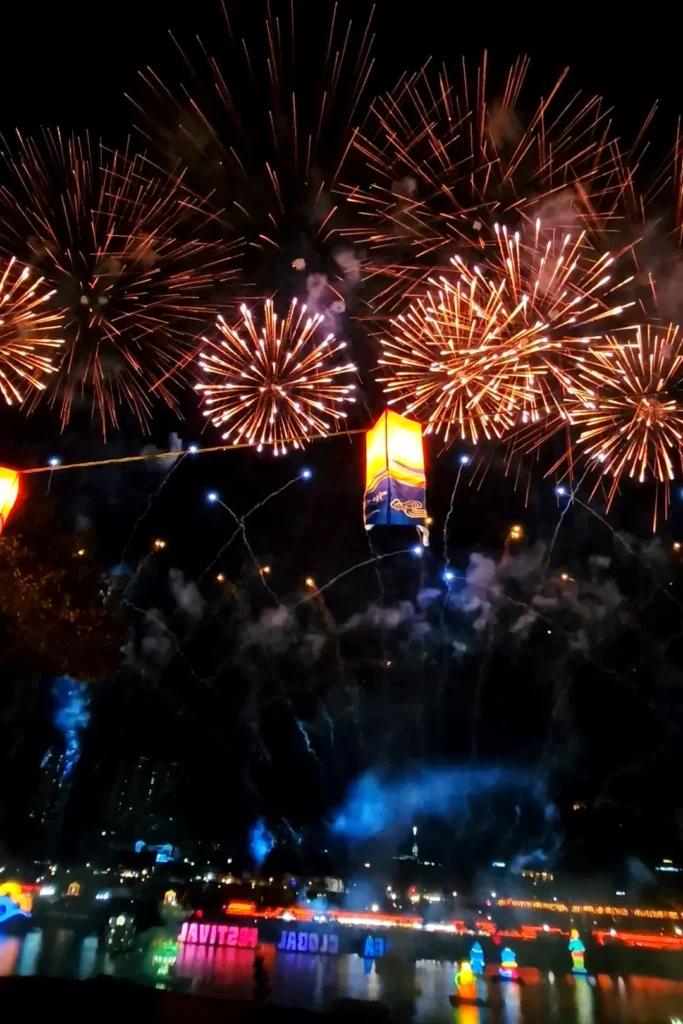Fireworks filling the night sky above lantern displays on the Namgang River during the Jinju Namgang Yudeung Festival.